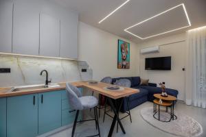 a kitchen and living room with a blue couch at Aristotelous rooms Nikol in Thessaloniki