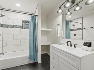 une salle de bain blanche avec une douche et un lavabo dans l'établissement Spacious 4 Bedroom Family Retreat in the Heart of McKinney, TX, à McKinney 37 autres photos