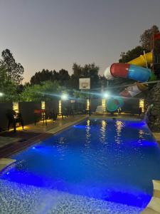 a pool at night with a water slide at My Ideal Eldorado in Eldorado