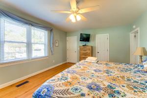 a bedroom with a bed and a ceiling fan at 1 Mi to Historic District! Family Home in New Bern in New Bern