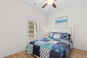 a bedroom with a bed and a ceiling fan at Munn Hub Live the Dream 4 Bdrm Home with Pool in Pawleys Island