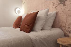 a bed with four pillows on top of it at Willow Hideaway in Arendonk