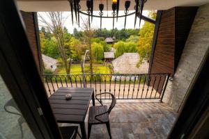 a porch with a table and chairs on a balcony at Hotel Castel Suceava in Suceava