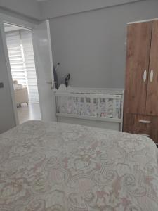 a bedroom with a bed and a baby crib at Oznur House in Dalaman