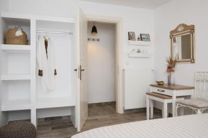 a bedroom with a bed and a desk and a mirror at Geronti Moscha Apartment in Apollonia +116 photos