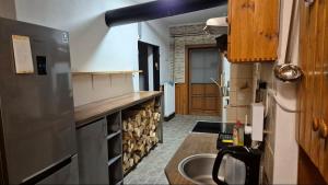 a kitchen with a stainless steel refrigerator and a sink at U Čertovy brázdy in Sázava