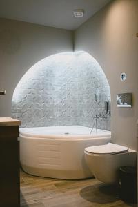 a bathroom with a bath tub in a stone wall at Downtown Hideaway in Thessaloniki +65 photos