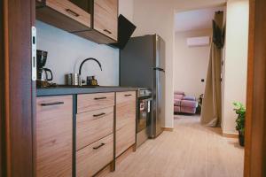 a kitchen with a sink and a refrigerator at Downtown Hideaway in Thessaloniki