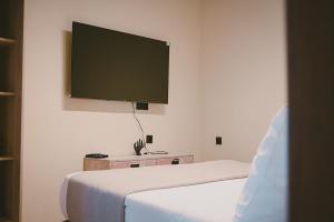 a bedroom with two beds and a flat screen tv at Downtown Hideaway in Thessaloniki