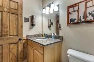 a bathroom with a sink and a mirror at Deck and Sauna Avalon Woods Riverfront Retreat in Marble +37 photos