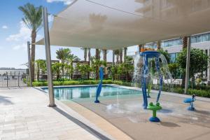 a water park with a fountain in a pool at Address Marassi Residence, Bahrain in Manama
