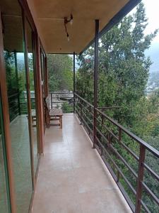 a balcony of a house with a view of trees at Green Paradise in Ijevan