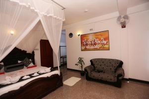 um quarto com uma cadeira, uma cama e um quadro em La Montagna em Ella