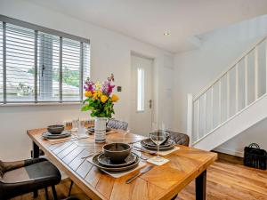 a dining room table with a vase of flowers on it at 1 bed in Mamhilad 83405 in Mamhilad +20 photos