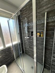 a shower with a glass door in a bathroom at Appartamento Vacanza Centro Asti in Asti