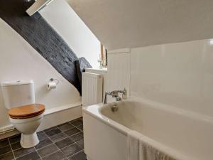 a bathroom with a toilet and a bath tub at 2 Bed in Llanover 91242 in Abergavenny +16 photos