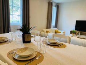 a dining room table with plates and glasses on it at Border Lodge in Évrange