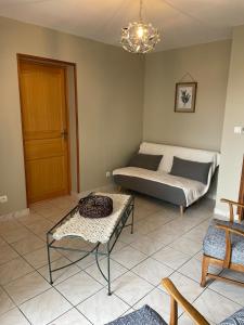 a bedroom with a bed and a table in it at Maison de campagne Lac de Vouglans in Onoz