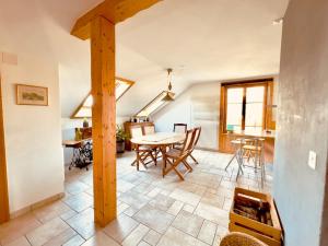 a kitchen and dining room with a table and chairs at Chez Pierre et Fabienne in Le Locle