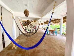 a hammock in a room in a house at Hotel Papaya Surf in Puerto Escondido +61 photos