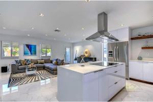 a kitchen and a living room with a couch at Magical Miami Retreat with Heated Pool, Mini Golf, and Basketball Court L19 in Miami