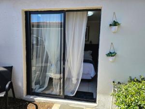 a sliding glass door leading to a bedroom at The Little Haven in Midrand +10 photos