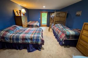 a bedroom with two twin beds and a bunk bed at Timber Creek #100 in Podunk +25 photos