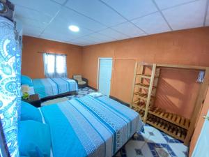 a bedroom with two beds and a ladder in it at Casa Cahuí in El Remate