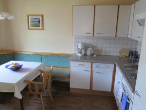 a kitchen with a table and a table and chairs at Appartment Nill in Hippach