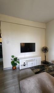 a living room with a flat screen tv on a wall at Kisumu Airview Homestay in Kisumu