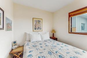 a bedroom with a bed and a window at Neil's Cabin in Pacific City