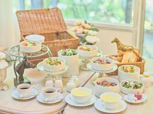 a table topped with cups and saucers of food at Auberge de Primavera - Vacation STAY 40843v in Shin-karuisawa +7 photos
