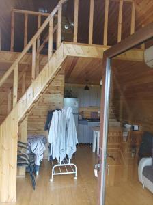 a room with a staircase in a wooden house at Koxta in Akhaliki