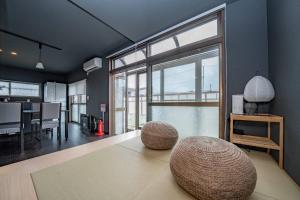 a living room with a large window and a table at VIOLET GARDEN - Vacation STAY 37201v in Furano