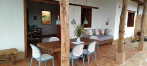 a living room with a wooden table and chairs at Casa Ángel in Barichara