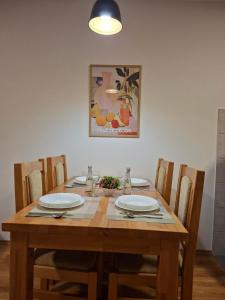 a wooden table with four chairs and a dining room at Stan na dan Ramonda in Donje Mladice +5 photos