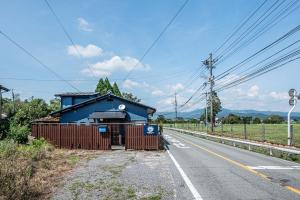 a blue building on the side of a road at Aso Play - Harmony and Unity - Vacation STAY 42457v in Uchinomaki