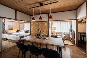 a living room with a bed and a table and chairs at Aso Play - Harmony and Unity - Vacation STAY 42457v in Uchinomaki