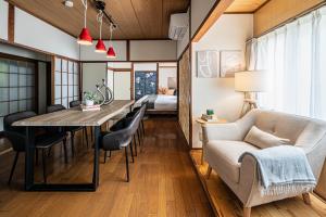a living room and dining room with a couch and a table at Aso Play - Harmony and Unity - Vacation STAY 42457v in Uchinomaki