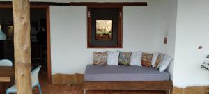a bed in a room with a mirror on the wall at Casa Ángel in Barichara