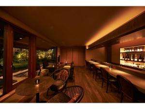 a restaurant with tables and chairs and a bar at Auberge de Primavera - Vacation STAY 40819v in Shin-karuisawa
