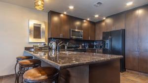 a kitchen with a granite counter top and wooden cabinets at 2BR 2BA condo @ Las Palomas Cabrillo 804 in Puerto Peñasco