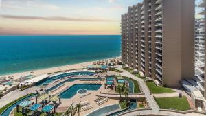 an aerial view of a resort with a pool and the ocean at 2BR 2BA condo @ Las Palomas Cabrillo 804 in Puerto Peñasco