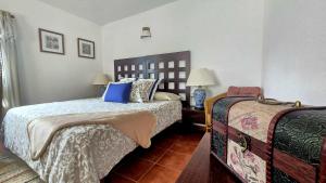 a bedroom with two beds and a table with lamps at The Haven of Happiness in Fátaga
