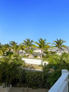 a view from the balcony of a resort with palm trees at Villa Mia in Orient Bay