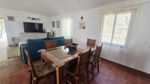 a living room with a table and a blue couch at The Haven of Happiness in Fátaga