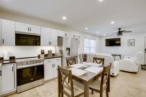 a kitchen and living room with a table and chairs at Wooded Retreat with Pet-Friendly Yard in Standish in Standish +17 photos