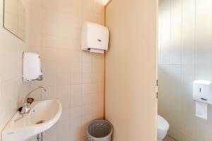 a bathroom with a sink and a toilet at LummersDorf in Sankt Johann am Wimberg +21 photos