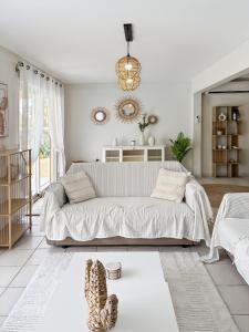 a white bedroom with a bed and a mirror at Villa Mia in Orient Bay +36 photos
