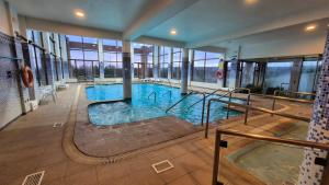 a large swimming pool in a building at Hotel y Cabañas Llanuras de Diana - Caja Los Andes in Puerto Natales